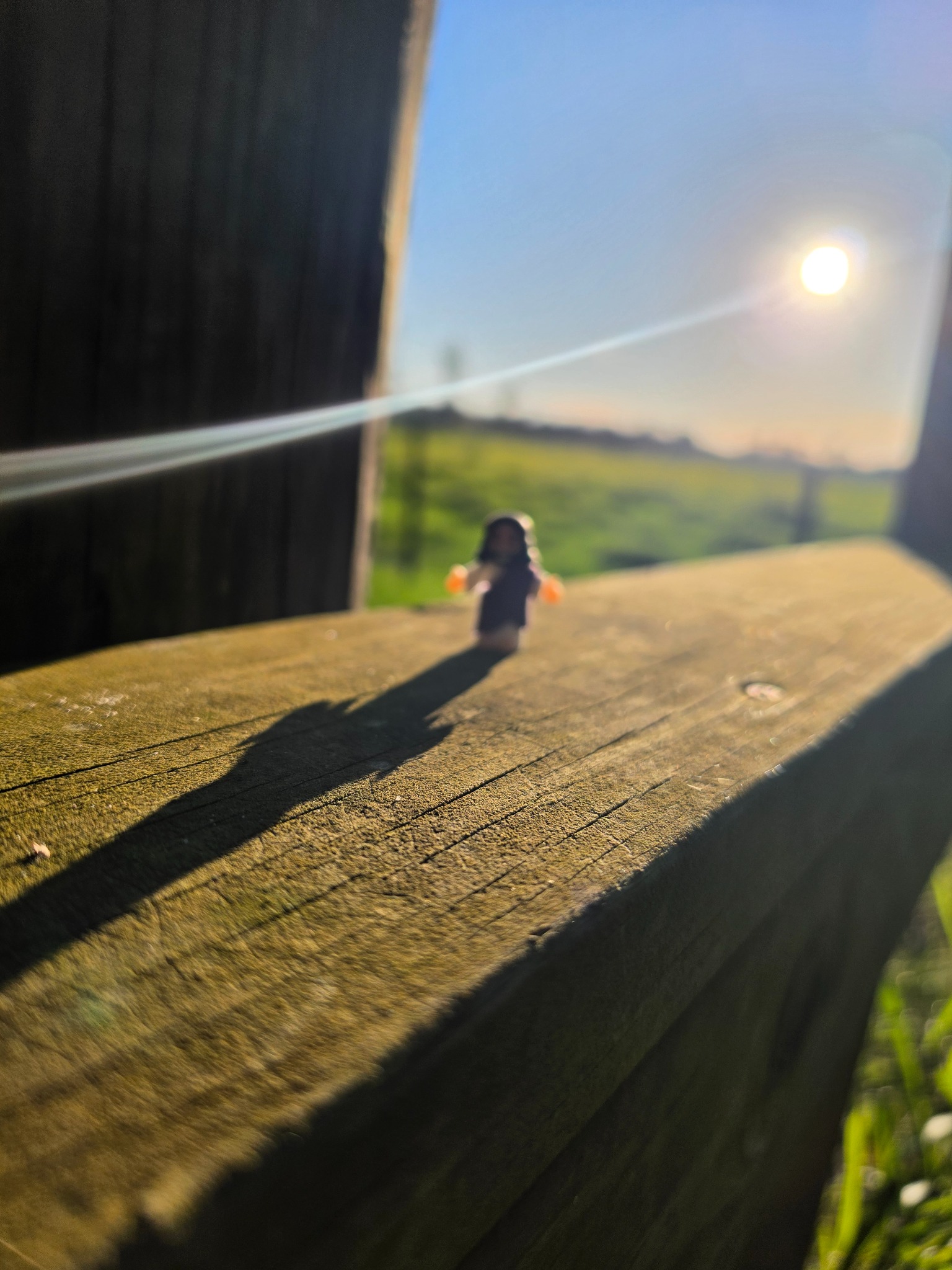 A small Jesus figurine photographed in sunlight